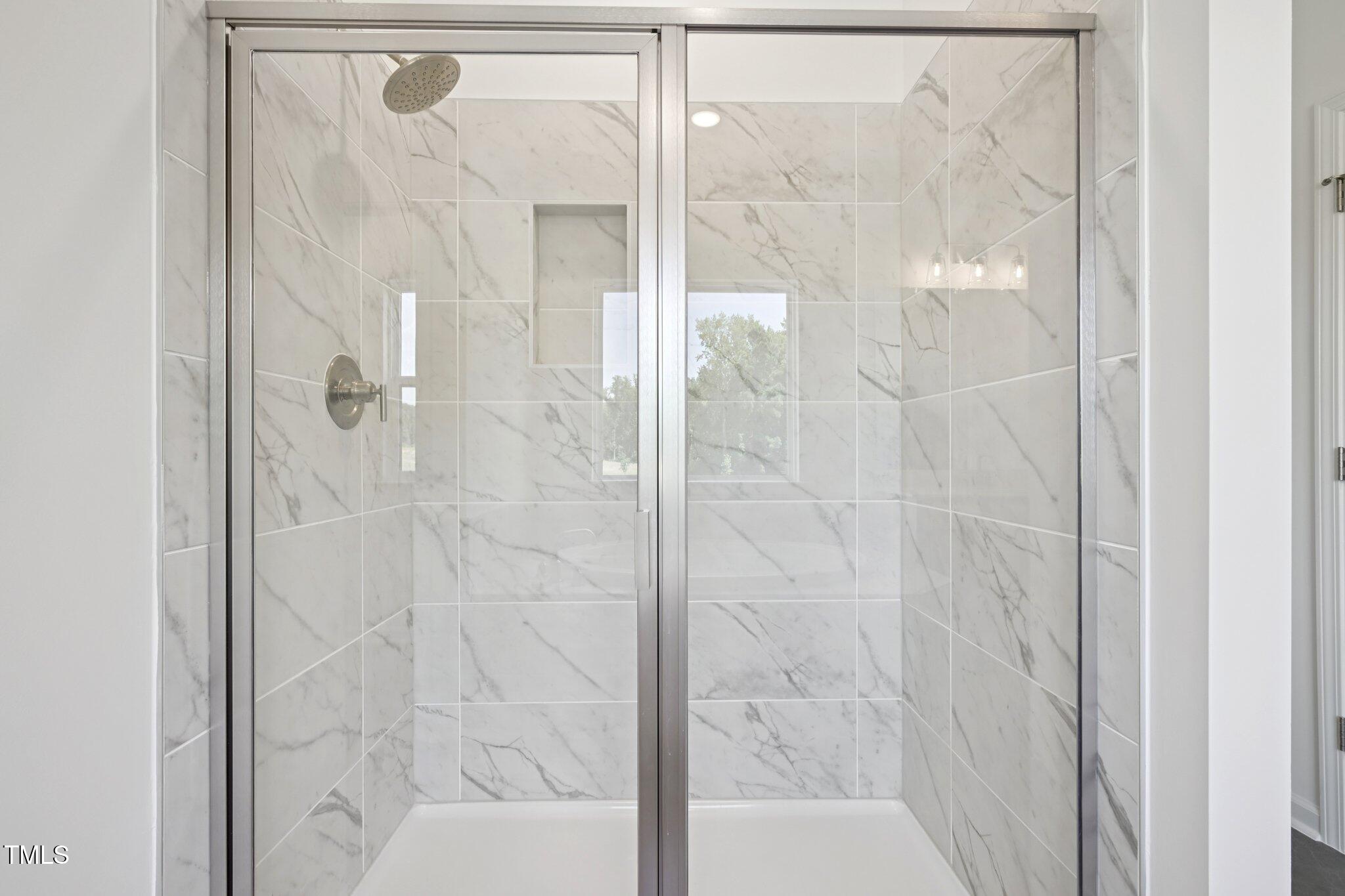 1609 Malcus Court, Unit 67 Fuquay-Varina, NC 27526 - Photo 26 of 40 a bathroom with a glass shower door