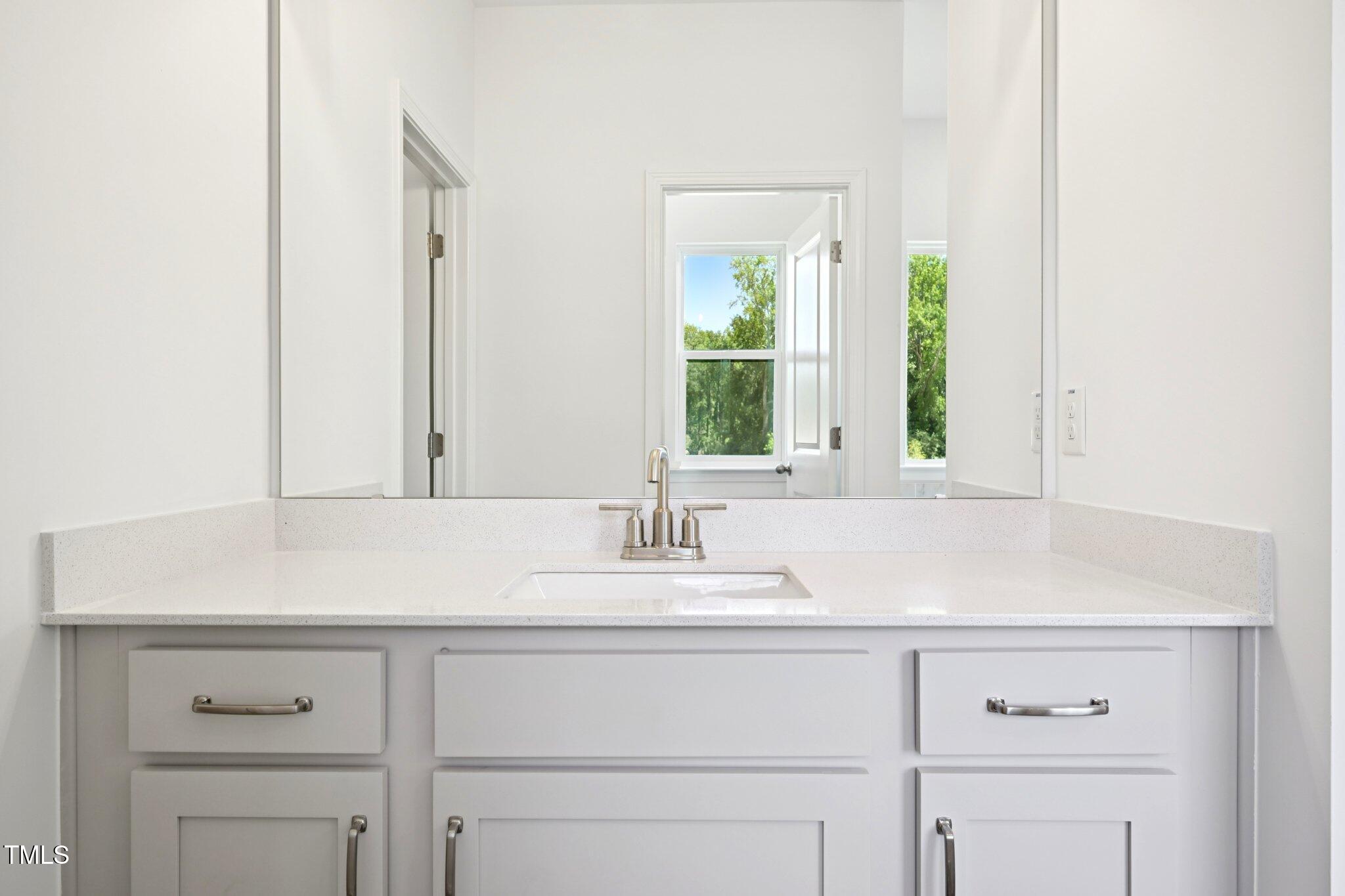 1609 Malcus Court, Unit 67 Fuquay-Varina, NC 27526 - Photo 27 of 40 a bathroom with a sink and a window