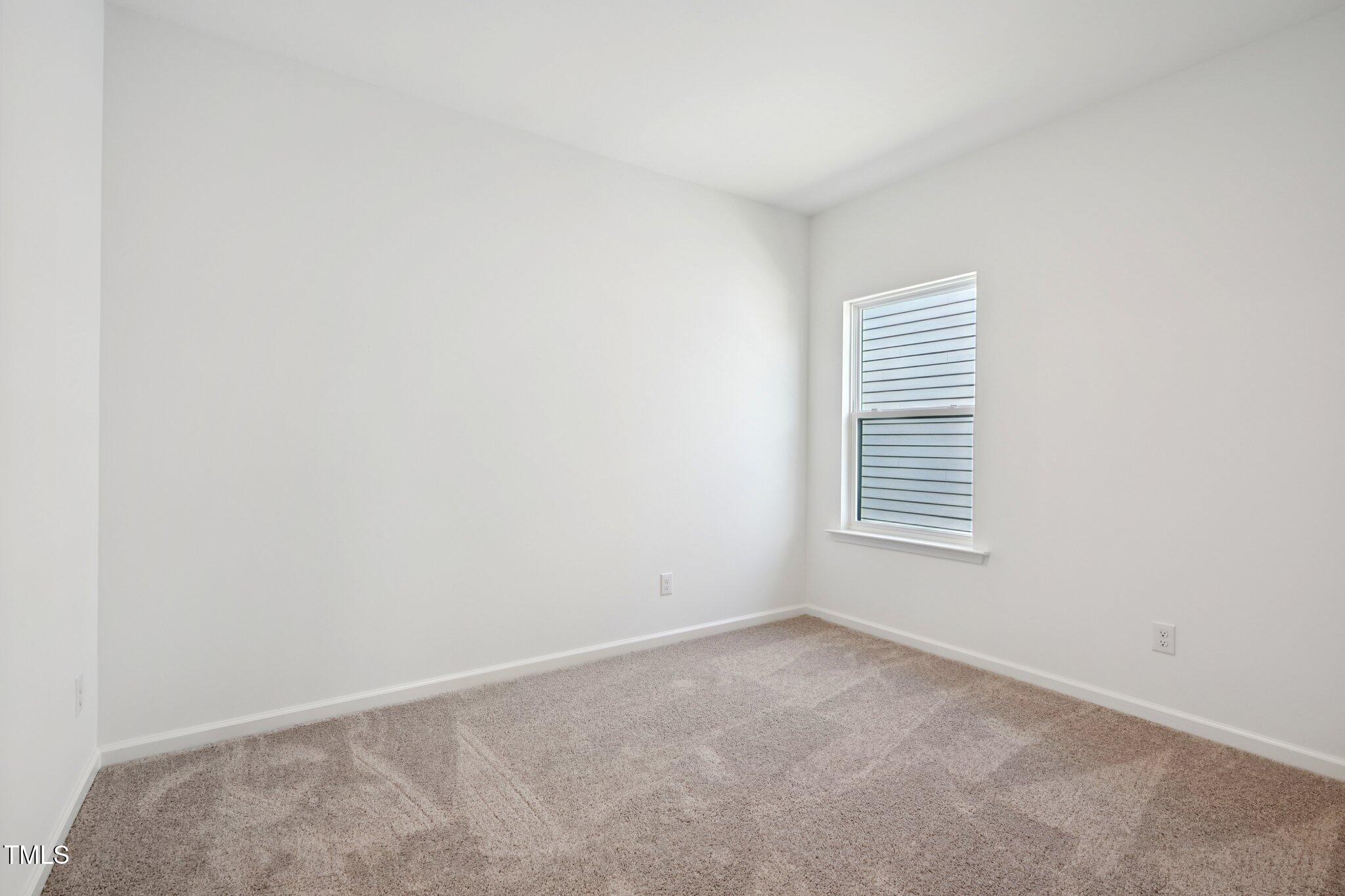 1609 Malcus Court, Unit 67 Fuquay-Varina, NC 27526 - Photo 28 of 40 a view of an empty room with a window