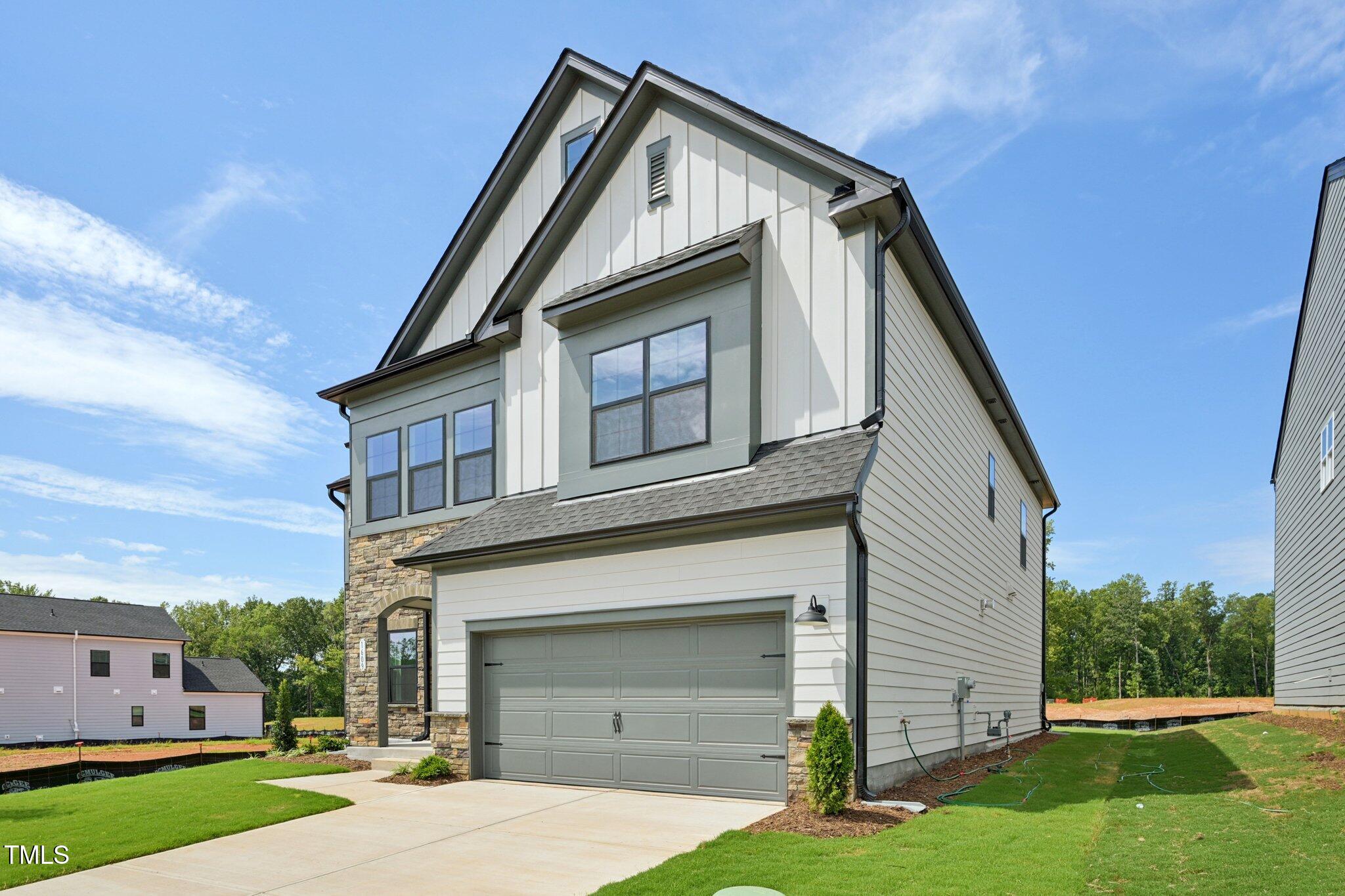 1609 Malcus Court, Unit 67 Fuquay-Varina, NC 27526 - Photo 2 of 40 a front view of a house with a yard and garage