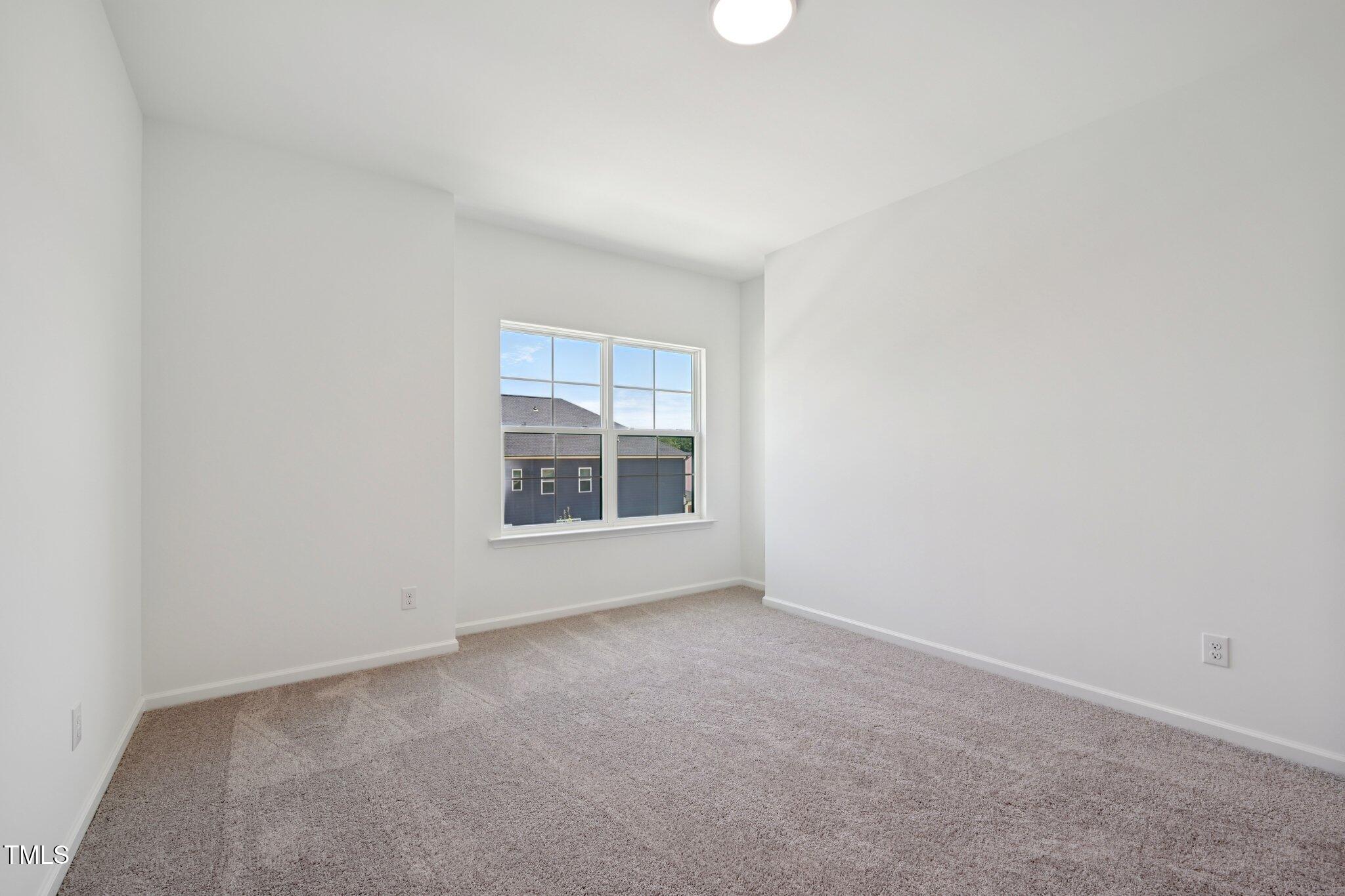 1609 Malcus Court, Unit 67 Fuquay-Varina, NC 27526 - Photo 34 of 40 a view of an empty room with a window