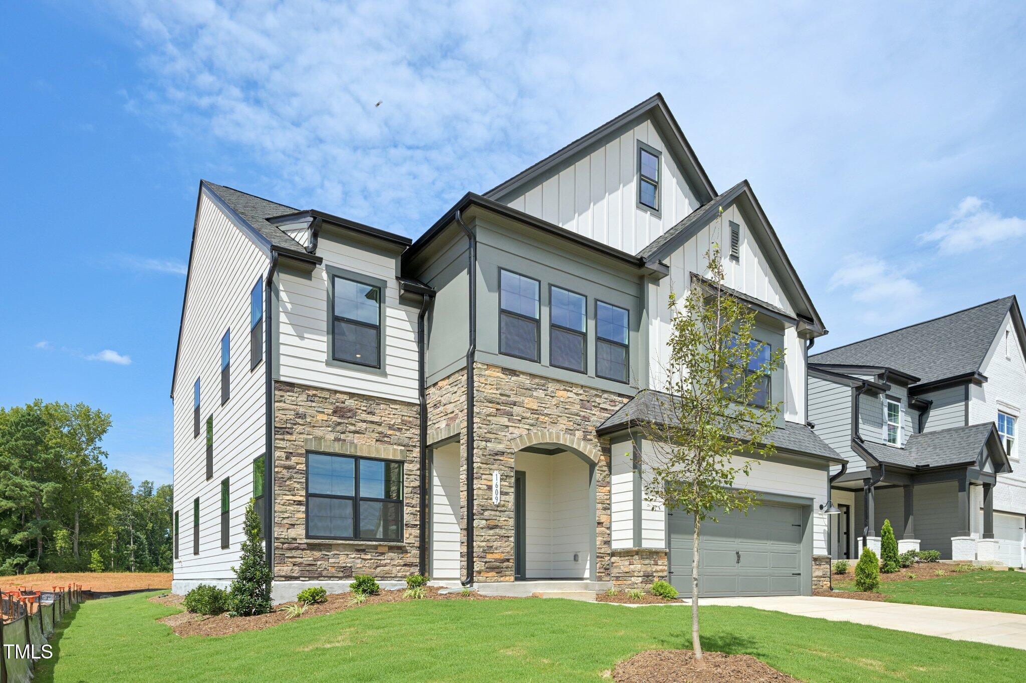 1609 Malcus Court, Unit 67 Fuquay-Varina, NC 27526 - Photo 3 of 40 a front view of a house with a yard