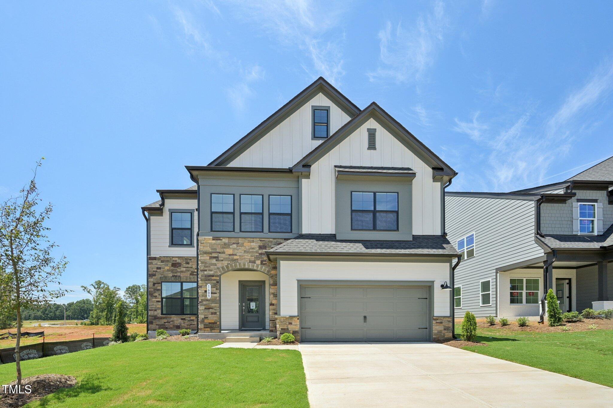 1609 Malcus Court, Unit 67 Fuquay-Varina, NC 27526 - Photo 4 of 40 a front view of a house with a garden and yard