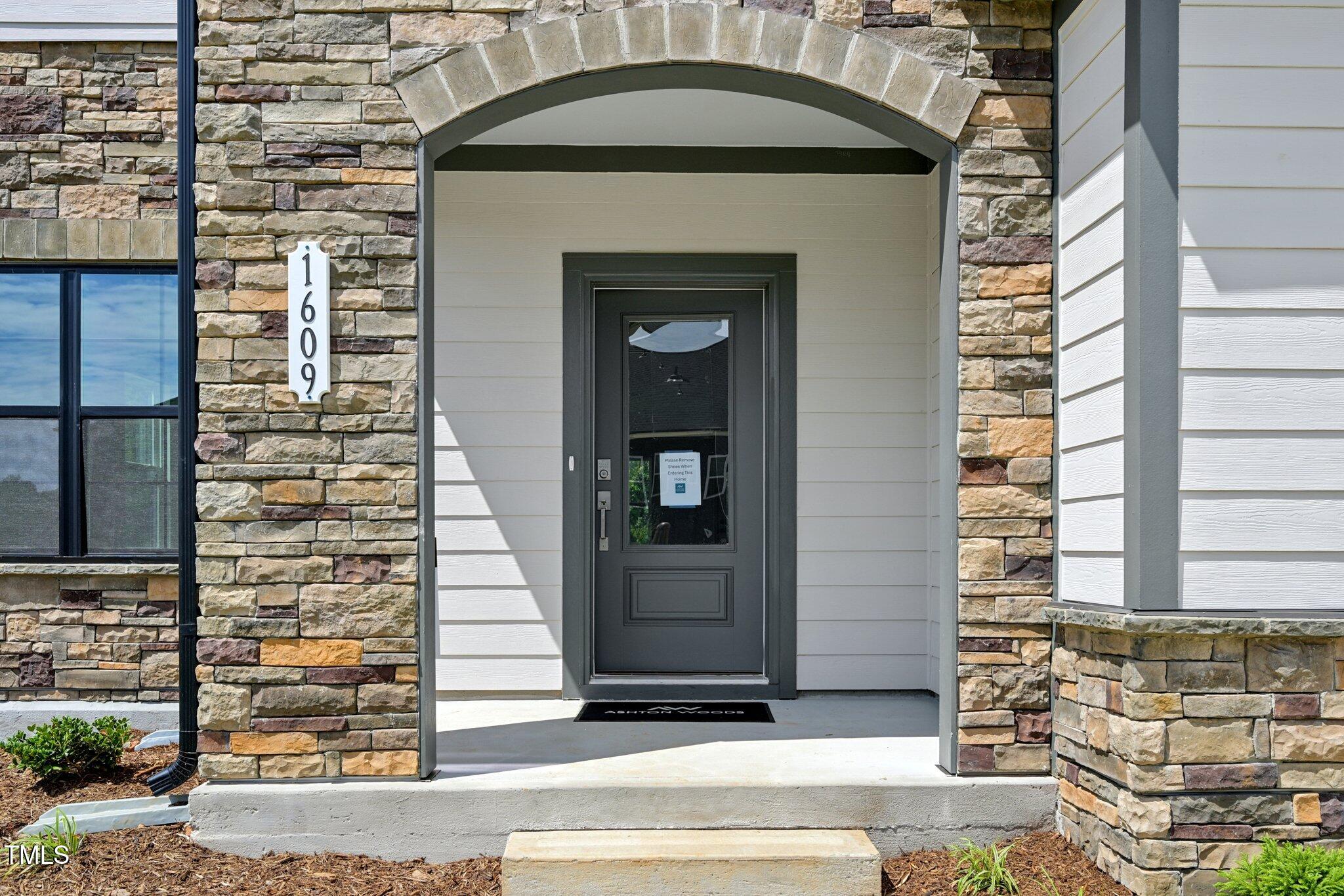 1609 Malcus Court, Unit 67 Fuquay-Varina, NC 27526 - Photo 5 of 40 a front view of a house with a garden