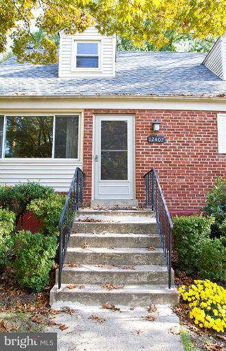12407 Denley Road Silver Spring, MD 20906 - Photo 2 of 30 a front view of a house with a garden