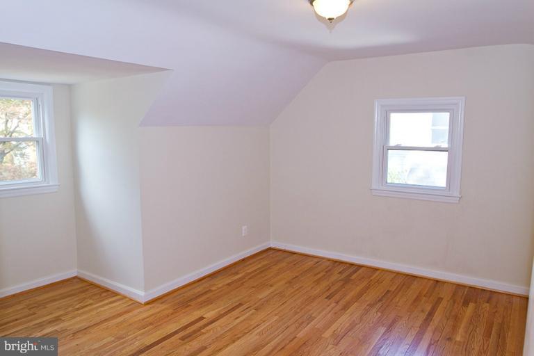 12407 Denley Road Silver Spring, MD 20906 - Photo 18 of 30 an empty room with wooden floor and windows