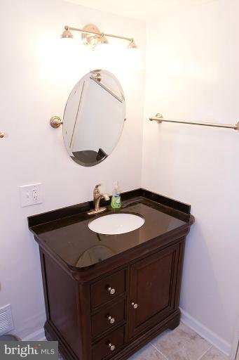 12407 Denley Road Silver Spring, MD 20906 - Photo 21 of 30 a bathroom with a sink and a mirror