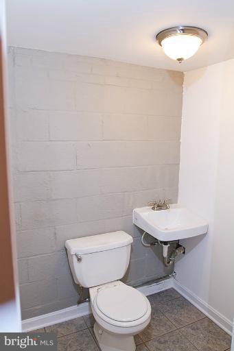 12407 Denley Road Silver Spring, MD 20906 - Photo 26 of 30 a white toilet sitting next to a bathroom sink