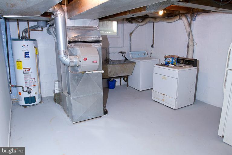 12407 Denley Road Silver Spring, MD 20906 - Photo 27 of 30 a storage room with washer and dryer