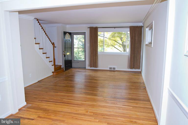 12407 Denley Road Silver Spring, MD 20906 - Photo 5 of 30 a view of an empty room with wooden floor and a window