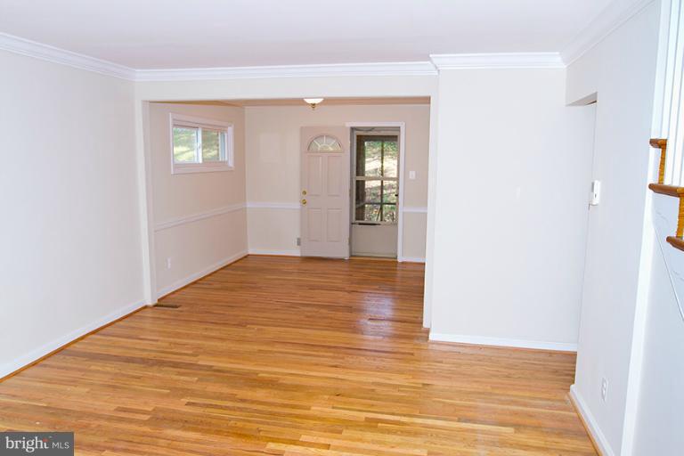 12407 Denley Road Silver Spring, MD 20906 - Photo 6 of 30 a view of an empty room with wooden floor and a window