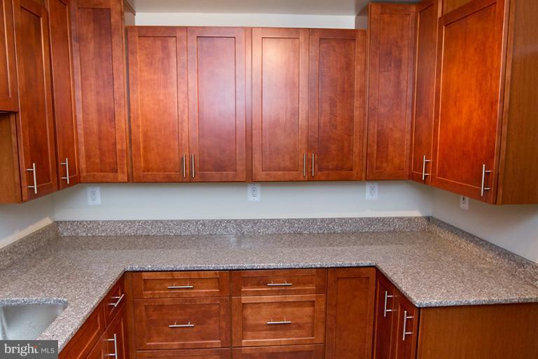 12407 Denley Road Silver Spring, MD 20906 - Photo 8 of 30 a kitchen with a sink and cabinets