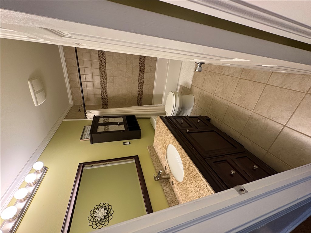 103 Elm Avenue Anderson, SC 29625 - Photo 11 of 19 This bathroom features a sleek vanity with a basin sink and a practical toilet.