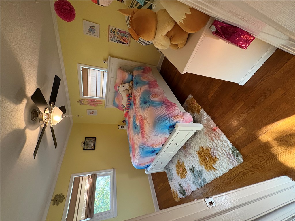 103 Elm Avenue Anderson, SC 29625 - Photo 13 of 19 This cozy bedroom features warm wood flooring and ample natural light from multiple windows.