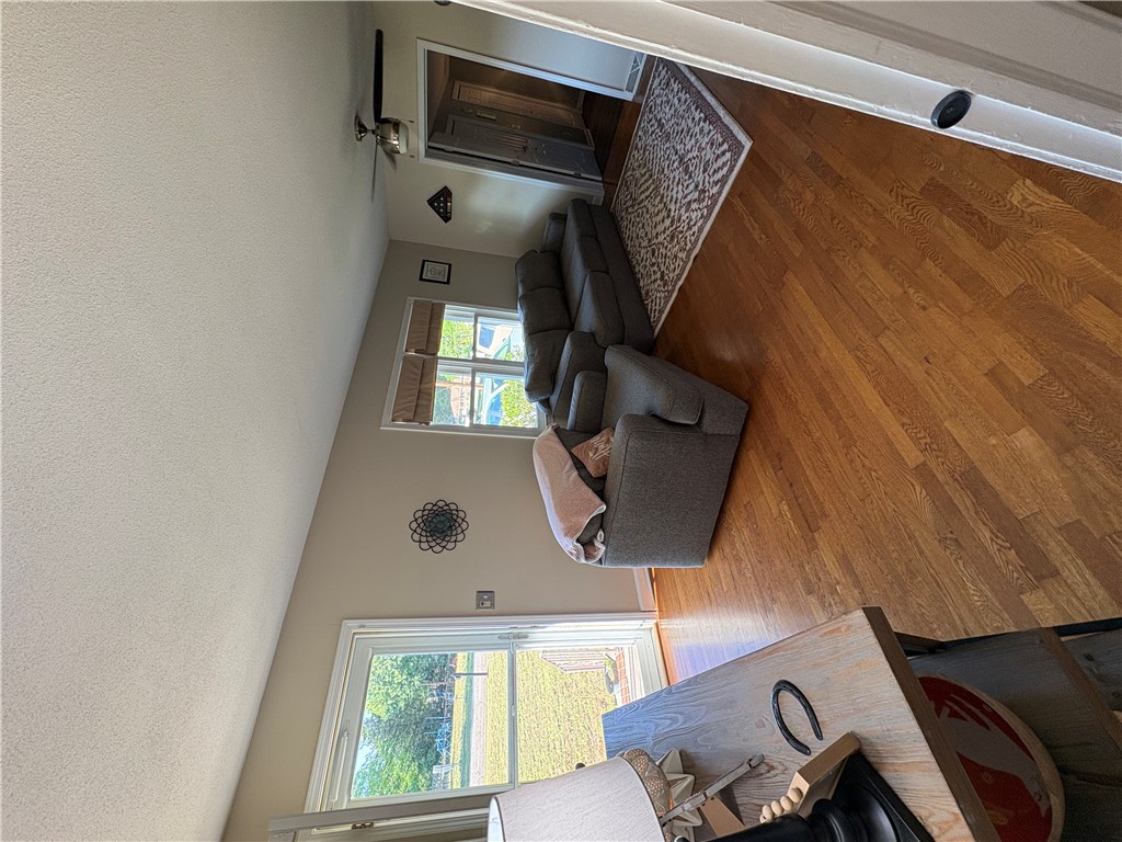 103 Elm Avenue Anderson, SC 29625 - Photo 16 of 19 This inviting living space features warm wood flooring and ample natural light, creating a comfortable atmosphere.