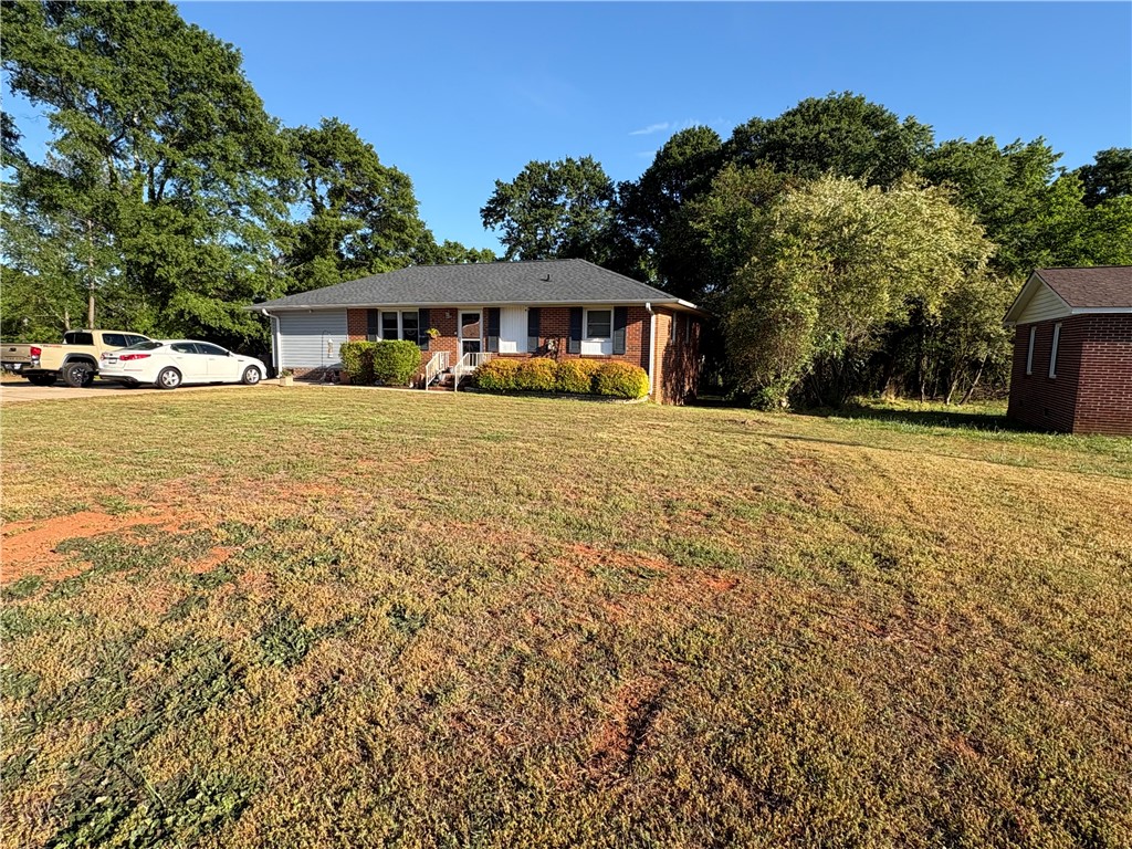 103 Elm Avenue Anderson, SC 29625 - Photo 8 of 19 This charming home features a brick and siding exterior, offering both durability and aesthetic appeal.