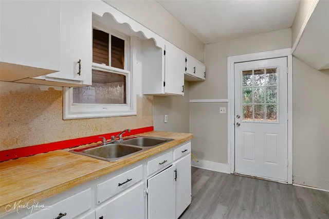 a kitchen with a sink cabinets and window