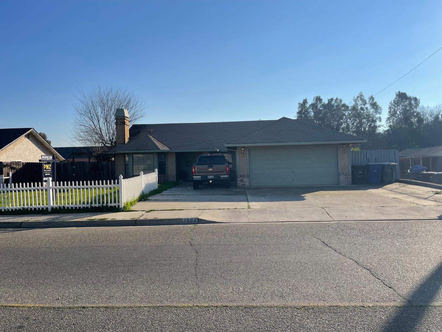 a view of a house with a outdoor space and seating area