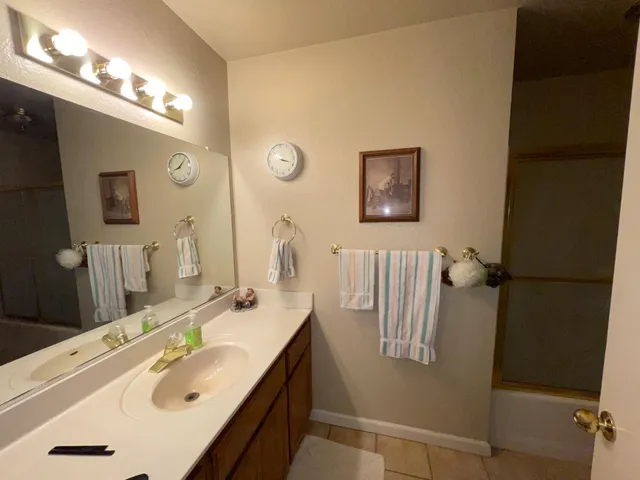 a living room with furniture fireplace and a large window