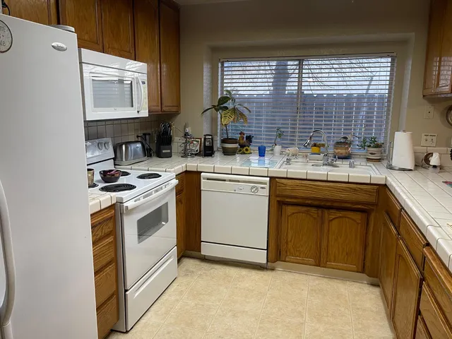 a kitchen with a stove a sink and a microwave
