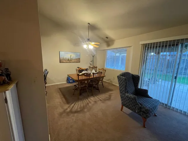 a view of a dining room with furniture and chandelier