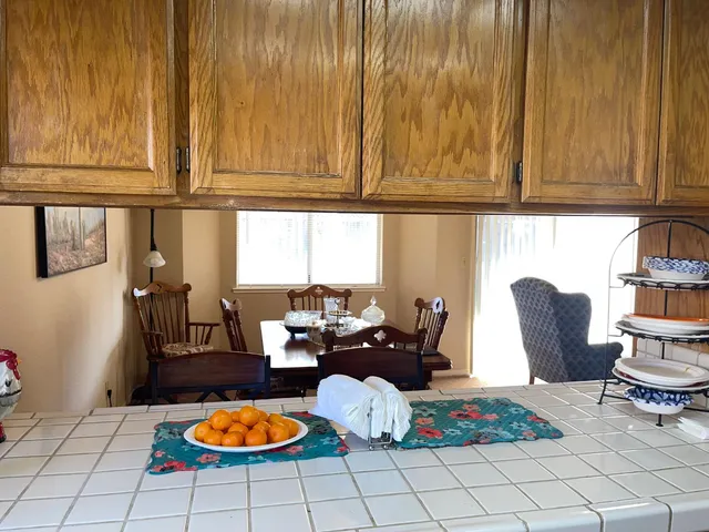 a white toilet sitting next to a bathroom sink and vanity