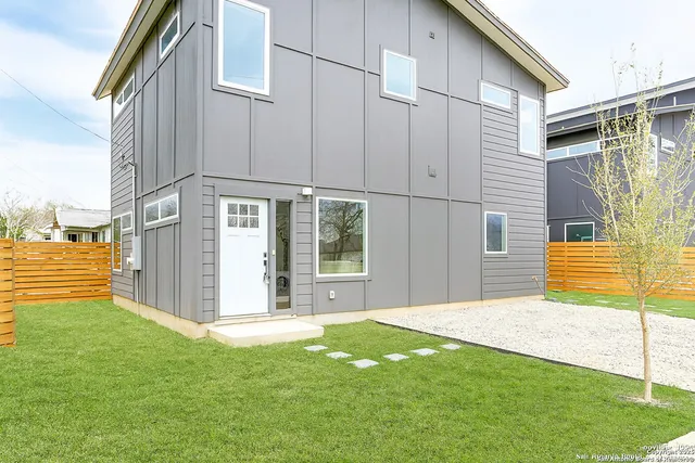 a view of a house with backyard and sitting area