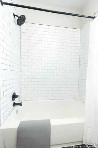 a bathroom with a shower and a bathtub