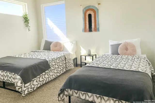 a bedroom with a bed mirror and window