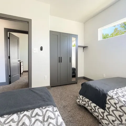 a bedroom with a bed and a dresser