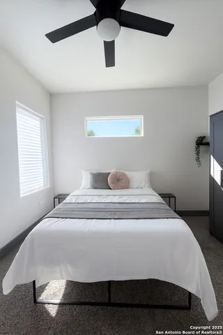 a bedroom with a bed and window