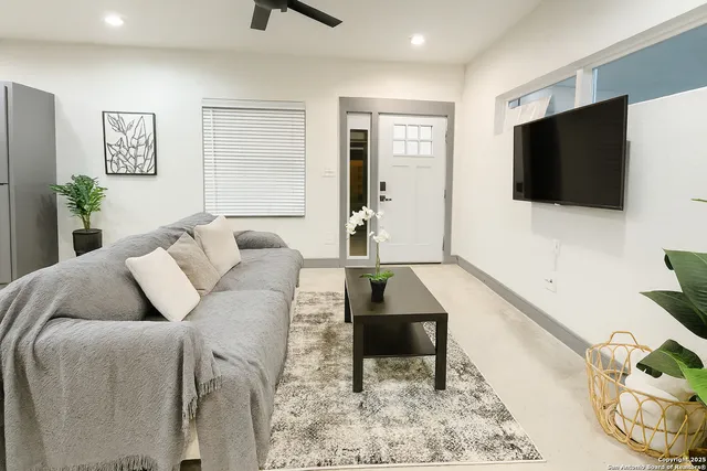 a living room with furniture and a flat screen tv