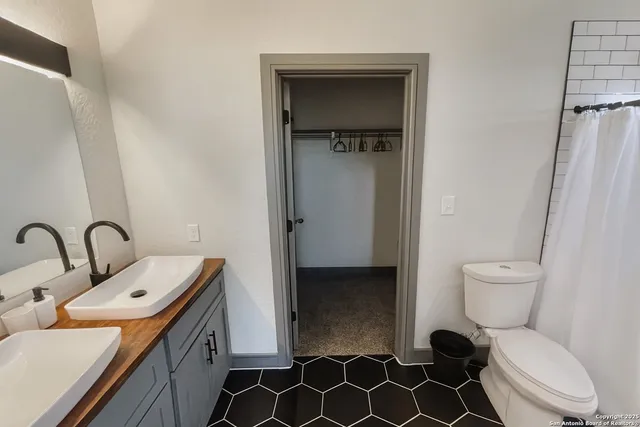 a bathroom with a toilet sink and mirror