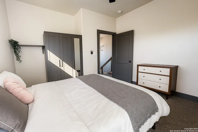 a bedroom with a bed and a dresser