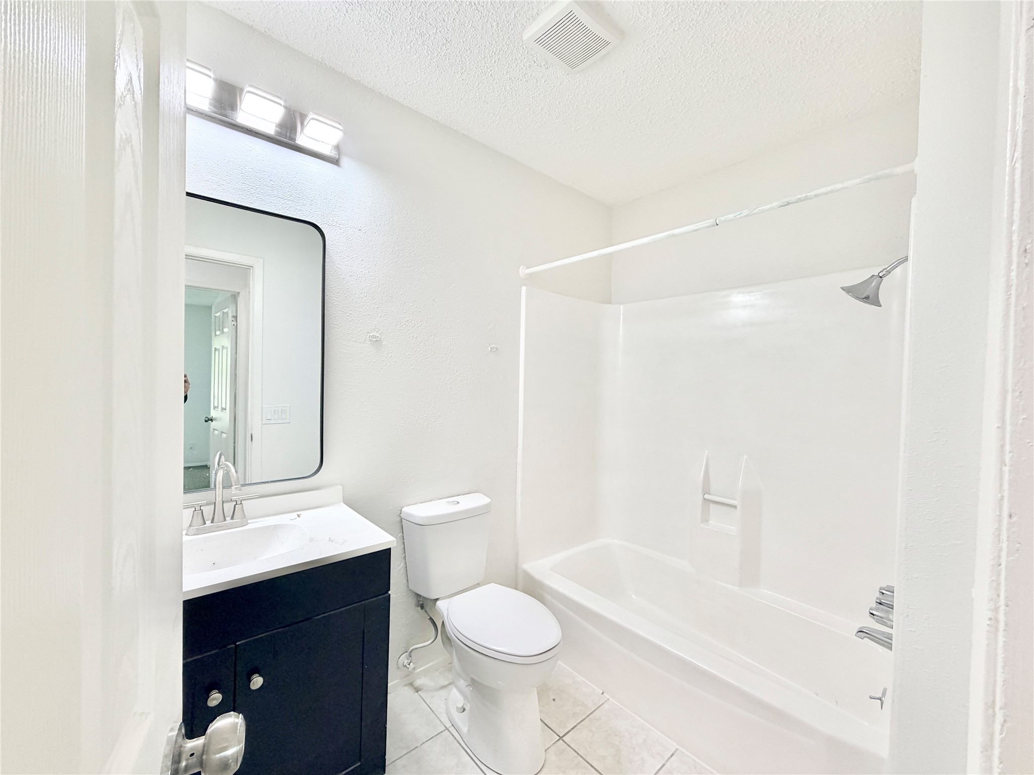 9623 Covey Ridge Lane Austin, TX 78758 - Photo 29 of 40 a bathroom with a sink a toilet and shower