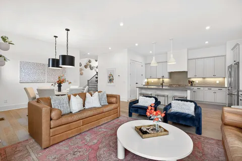 a living room with furniture and kitchen view