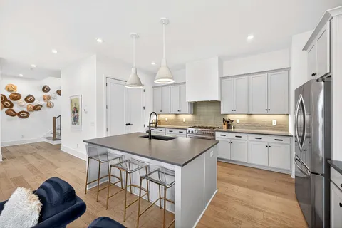 a kitchen with a sink stove and refrigerator