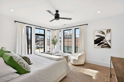 a bedroom with a large bed and a large window