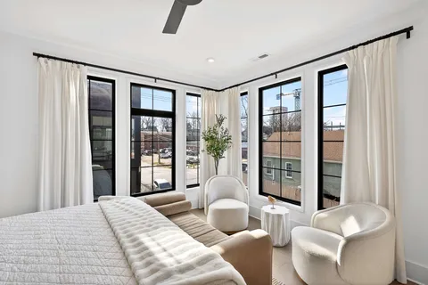 a bedroom with a large bed and a large window