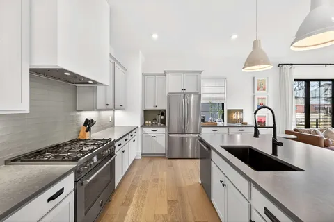 a kitchen with a sink stove and refrigerator