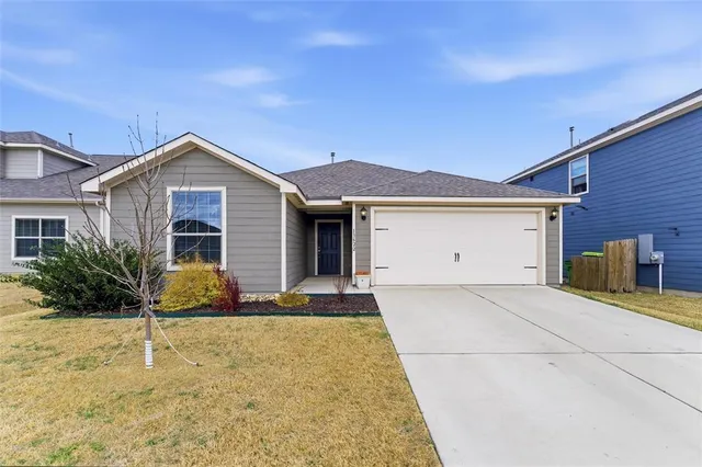 a front view of a house with yard
