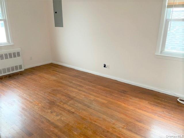 77 Kentucky Street, Unit UPPR Long Beach, NY 11561 - Photo 10 of 15 an empty room with wooden floor and windows