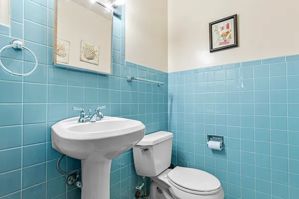 a bathroom with a sink toilet and mirror