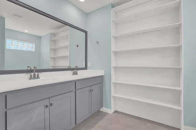 a bathroom with a double vanity sink and mirror