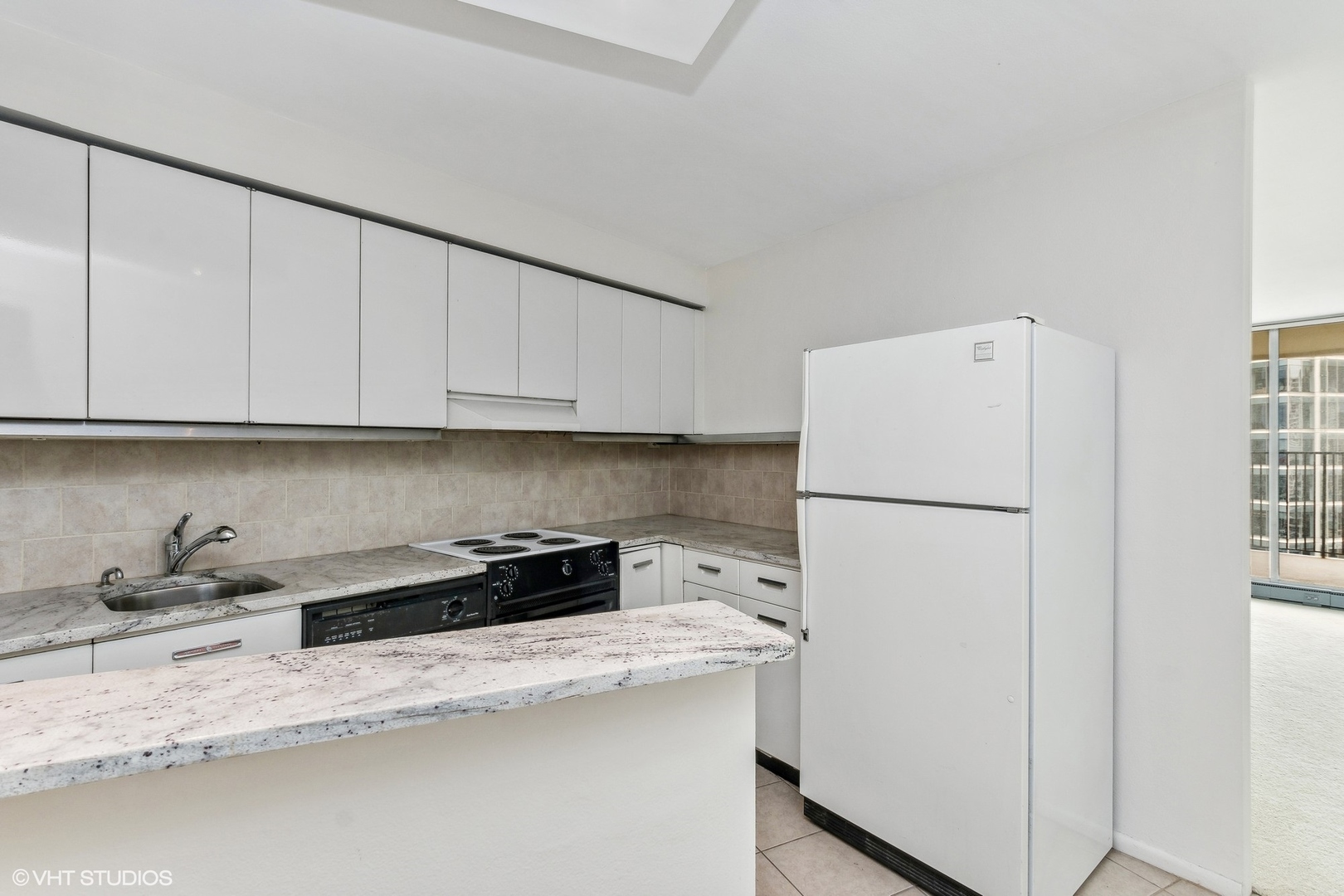 300 North State Street, Unit 4705 Chicago, IL 60654 - Photo 4 of 17 a kitchen with a refrigerator sink and cabinets