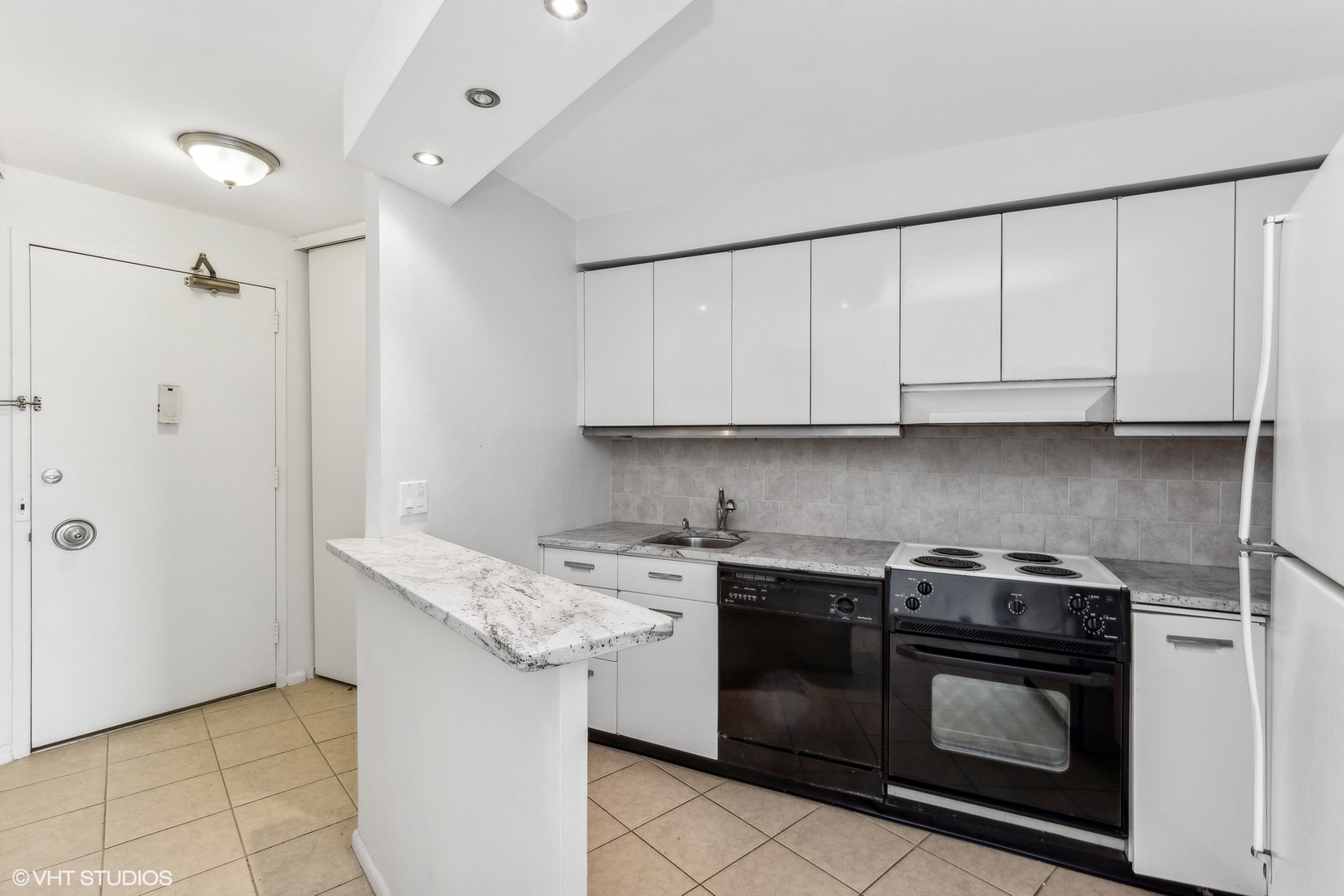 300 North State Street, Unit 4705 Chicago, IL 60654 - Photo 5 of 17 a kitchen with stainless steel appliances granite countertop a stove a sink and a microwave