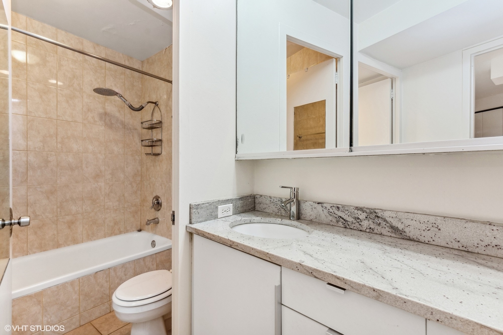 300 North State Street, Unit 4705 Chicago, IL 60654 - Photo 8 of 17 a bathroom with a granite countertop sink a toilet and bathtub