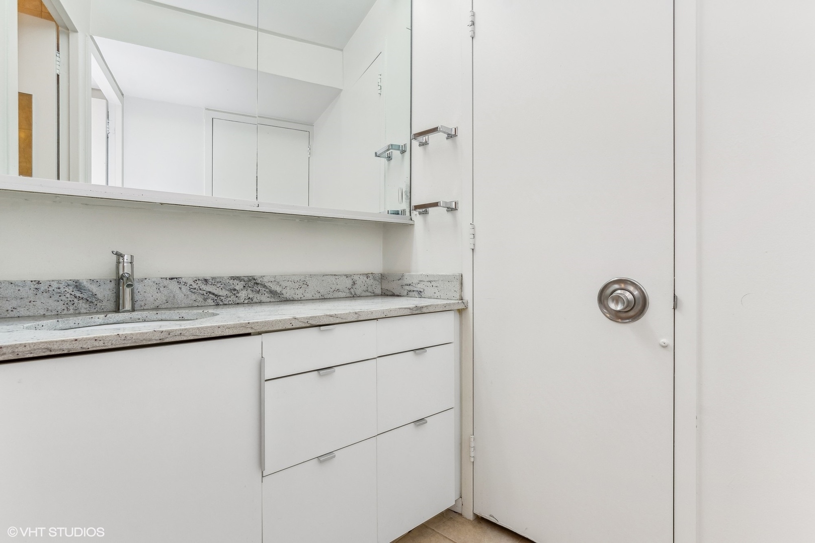 300 North State Street, Unit 4705 Chicago, IL 60654 - Photo 10 of 17 a kitchen with granite countertop cabinets and sink
