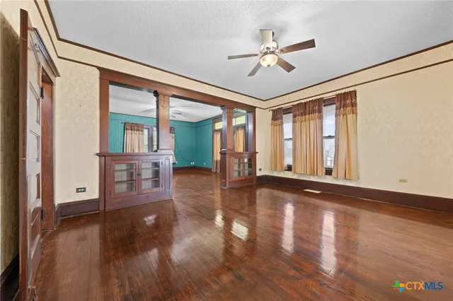 a view of livingroom with hardwood floor and ceiling fan