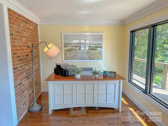 a view of a door and wooden floor in a room